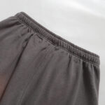 A close up view of the grey Hellstar Studios Records shorts focusing on the detailed elastic waistband construction