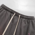 Detailed view of the grey Hellstar Studios Records shorts, focusing on the elastic waistband and white drawstrings.
