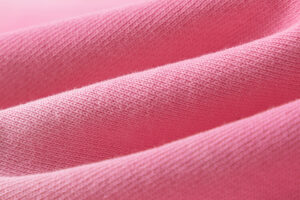 Close-up view of the premium soft pink fabric material used for Hellstar Studios Records casual shorts apparel.