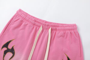 Close-up view of the elastic waistband and white drawstring on the Hellstar Studios Records pink shorts.