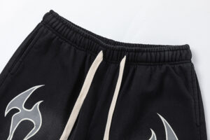 Close-up view of the black Hellstar Studios Records shorts featuring drawstring waistband and graphic star print details.