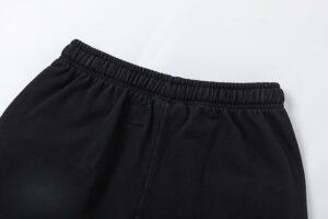 Close-up of the elastic waistband detail on the black Hellstar Studios Records vintage wash streetwear shorts.