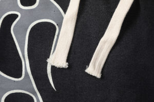 Close-up view of Hellstar Studios Records black shorts featuring white drawstring detail and graphic print pattern.