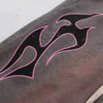 Close-up view of the grey Hellstar Studios Records shorts featuring the signature black and pink flame graphic print.