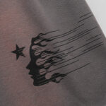 Close-up view of the Hellstar Studios Records grey shorts featuring a black flame-profile graphic and a star logo.