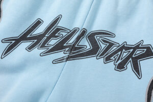 Close-up of light blue Hellstar Studios Records shorts featuring bold black screen-printed logo graphic detail.