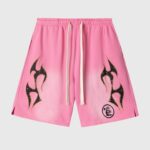 Pink Hellstar Studios Records shorts featuring vintage washed fabric, black flame graphic prints, and drawstring waist.