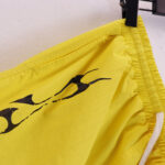 Close-up of the bright yellow Hellstar Studios Records Star shorts featuring black distressed graphic screen print detail.
