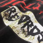 Close-up view of the unique graphic screen print design on the black Hellstar Studios Records vintage wash T-shirt.