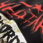 Close-up view of the vintage washed black Hellstar Studios Records T-shirt showcasing the detailed graphic screen print.