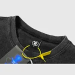 Close up view of the tag detail on a vintage washed black Hellstar Studios Records T-Shirt made of 100% cotton.