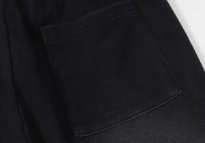 Close-up view of the practical pocket detail on the Hellstar Studios Records vintage black tracksuit pants.