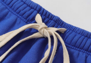 Close-up of the blue Hellstar Studios Records Yoga sweatpants showing the elastic waistband and drawstring detail.