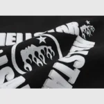 A detailed look at the white Hellstar Studios sketch graphic print featured on this black streetwear fleece hoodie.