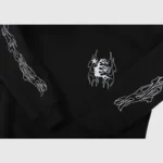 Close-up of the Hellstar Studios Sketch Hoodie featuring intricate white flame graphic details on the sleeves.