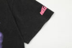 Close-up view of the black Hellstar Studios Brain Helmet T-Shirt sleeve featuring a vibrant pink logo graphic.
