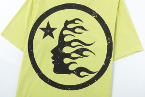 Hellstar Studios short sleeve T-shirt in yellow featuring a black circle graphic with a star and a flaming head silhouette