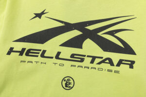 Close-up of the Hellstar Studios yellow graphic t-shirt featuring the black screen-printed logo and text design.