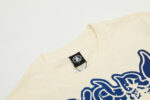 Hellstar Studios Yoga T-Shirt in beige, showcasing the crew neck detail and premium cotton branding label.