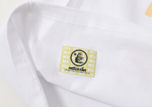 Hellstar Studios Yoga T-Shirt white featuring a detailed authentic branding neck label for verification purposes.