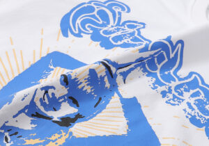 Close-up view of the premium white fabric texture on the Hellstar Studios Yoga T-Shirt featuring a blue graphic design.
