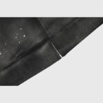 Close-up view of the premium black fabric and silver zipper detail on the Hellstar Studios zip-up hoodie for men.