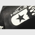 Close-up view of the Hellstar Studios black zip hoodie featuring a distressed white star logo graphic design.