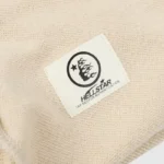 Close-up view of the Hellstar Studios Zipper Sweater authentication tag with logo and NFC scanning instructions.
