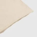 A detailed close-up showing the soft beige fabric texture of the premium Hellstar Studios zipper sweater knit.