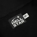 Close-up view of the branded Hellstar Studios woven label on a black premium cotton zipper sweater material.