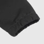 A close-up view of the ribbed sleeve cuff on the premium black Hellstar Studios zipper sweater in soft knit fabric.