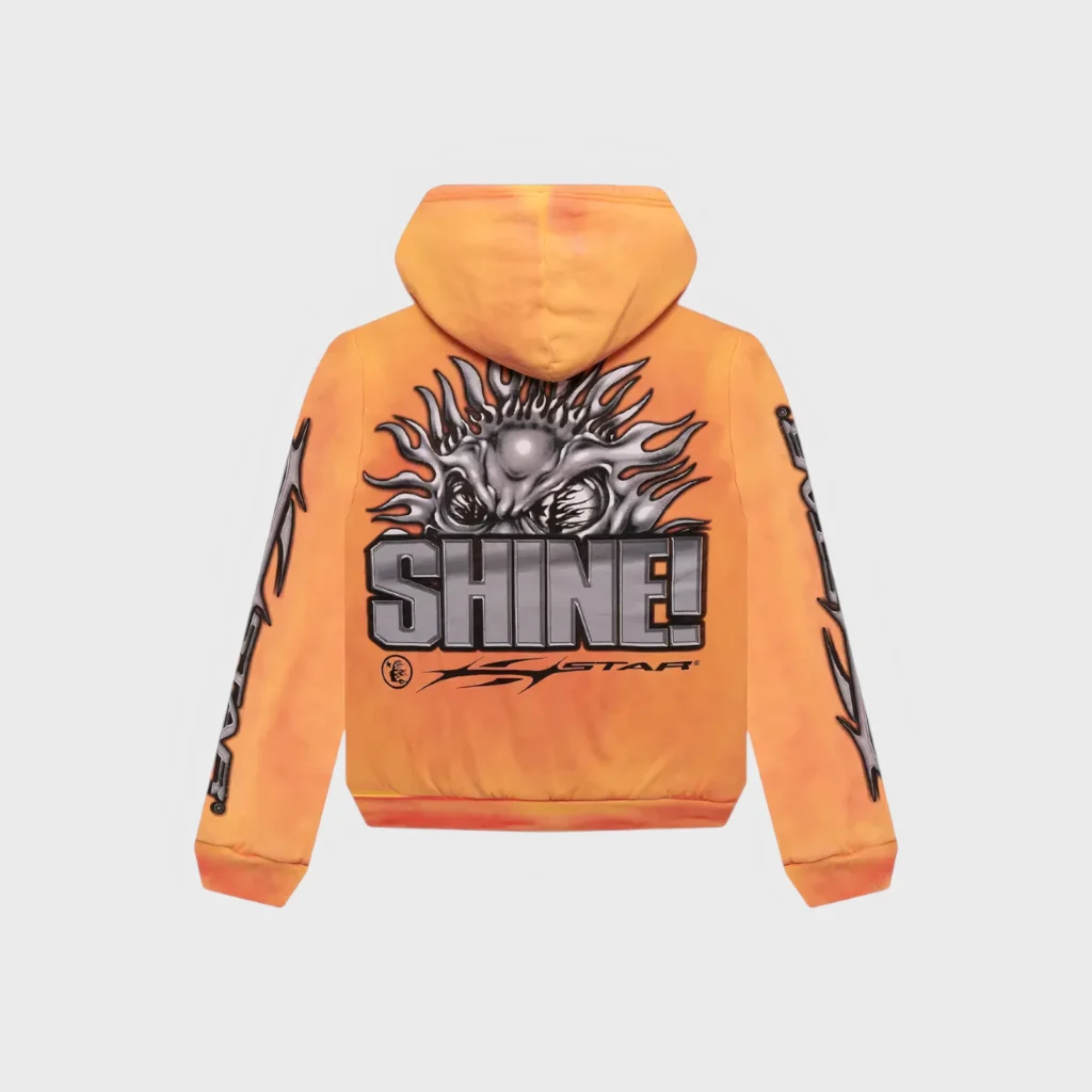 Back view of the orange Hellstar Sun zip-up hoodie featuring a bold silver Shine graphic design on the back.