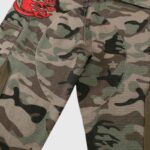 Close-up view of the Hellstar Supreme Camo Cargo Pants, highlighting the durable cotton fabric and vibrant red graphic.