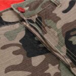 Close-up detail of the Hellstar Supreme Cargo Camo Pant, showcasing the rugged fabric, zipper fly, and button closure.