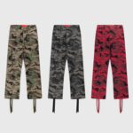 Three pairs of Hellstar Supreme Cargo Camo pants in brown, grey, and red, featuring durable fabric and utility pockets.
