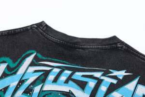 Close-up view of the neckline and graphic print on the black vintage washed Hellstar The Future Iconic T-shirt.