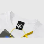 Close-up of the Hellstar The World Will Be Yours vintage wash white cotton T-shirt neck tag and branded label.