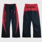 Hellstar Thriller black and red track pants featuring an embroidered logo, drawstring waist, and relaxed streetwear fit.