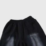 Close-up view of the back pocket and waist detailing on black Hellstar Uniform sweatpants with washed aesthetic.