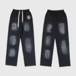 Front and back view of Hellstar Uniform sweatpants in black with a vintage washed graphic screen print finish.