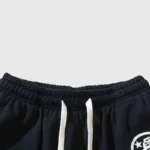 Hellstar Uniform Sweatpant close-up showing black gathered elastic waistband, white drawstring, and logo edge