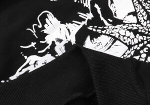 Close-up view of the white graphic screen print on the black Hellstar Victory Capsule 6 Hoodie fleece fabric.