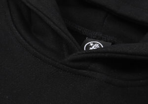 Close-up view of the interior brand label and stitching details on a black Hellstar Victory Capsule 6 cotton hoodie.