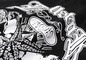 Close-up view of the white graphic print detail on a black Hellstar Victory Capsule 6 hoodie made from cotton fabric.