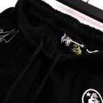 Detail view of Hellstar Vintage black fleece shorts featuring an adjustable drawstring waistband and signature graphics.