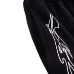 Detailed close-up view showing the signature white graphic print on black Hellstar vintage shorts fabric.