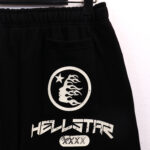 Black Hellstar vintage shorts featuring a distinctive circular logo graphic with a flame face and star print detail.
