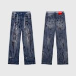 Front and back view of Hellstar vintage washed blue denim jeans featuring a graphic screen print pattern.