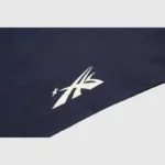 A close-up view of the white graphic logo on a blue Hellstar Warm Up unisex T-shirt with a vintage washed effect.