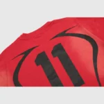 Detailed close-up of the black graphic on the back of the vintage washed red Hellstar Warm Up unisex cotton T-shirt